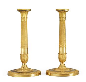 683. A pair of French Empire early 19th Century candlesticks.