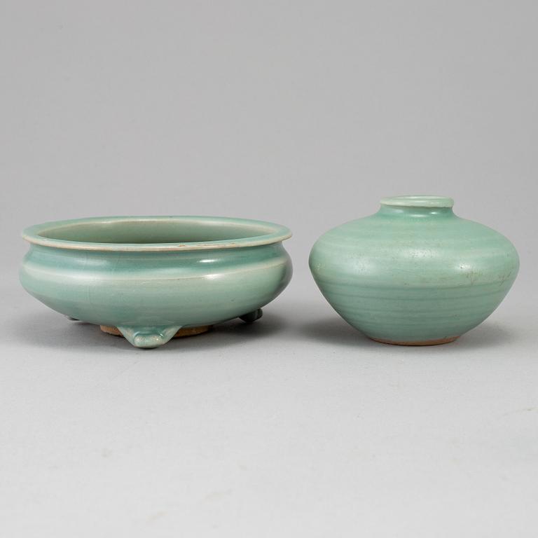 A celadon glazed tripod censer and a vase, Ming dynasty (1368-1644).