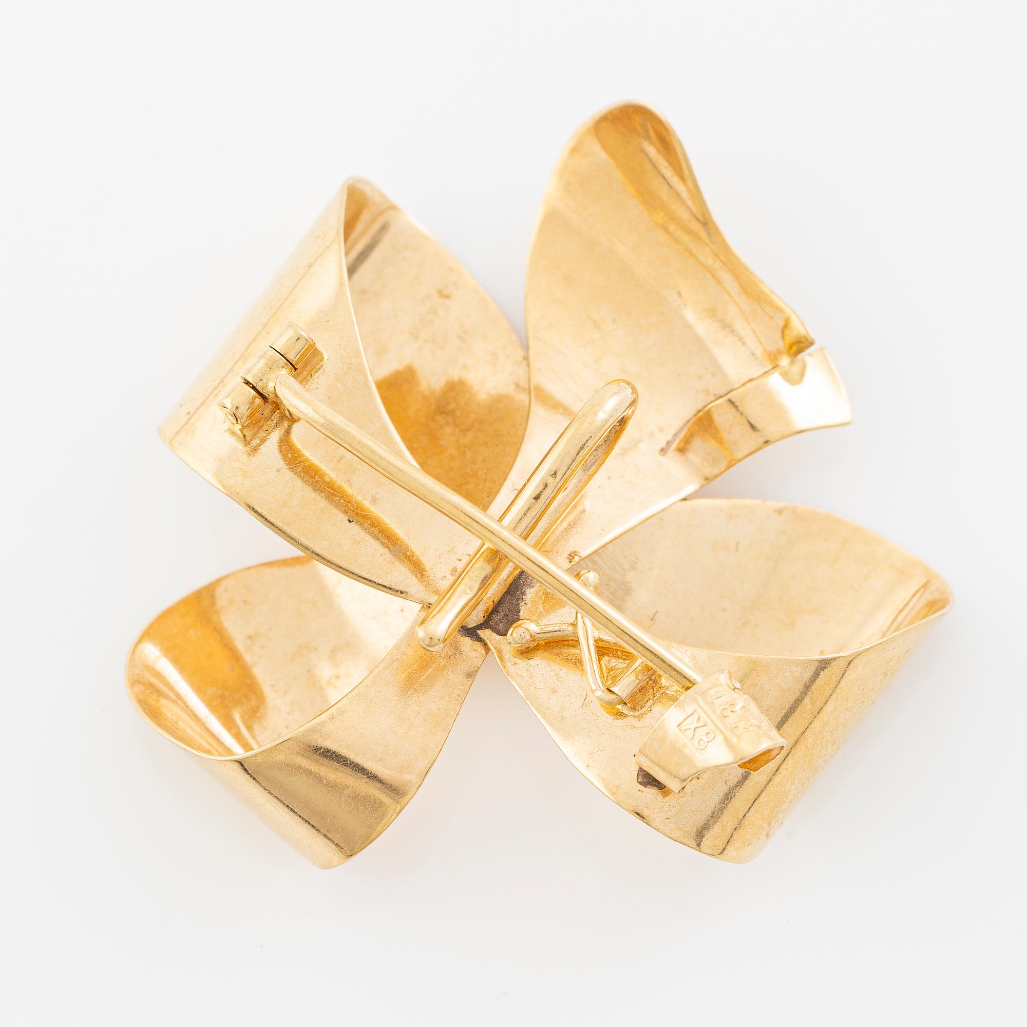 Brooch, 18K gold in the form of a bowknot.