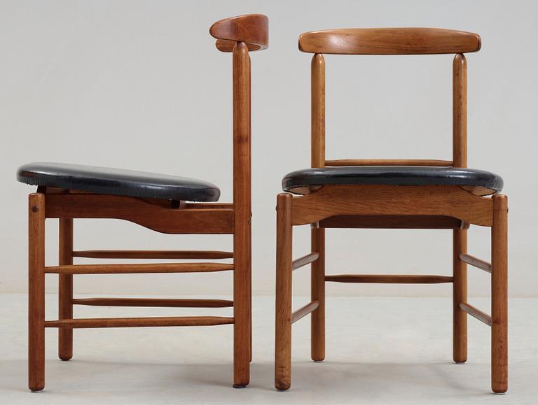 A pair of Greta Magnusson Grossman walnut and artificial leather chairs, for Glenn of California, USA 1950's.