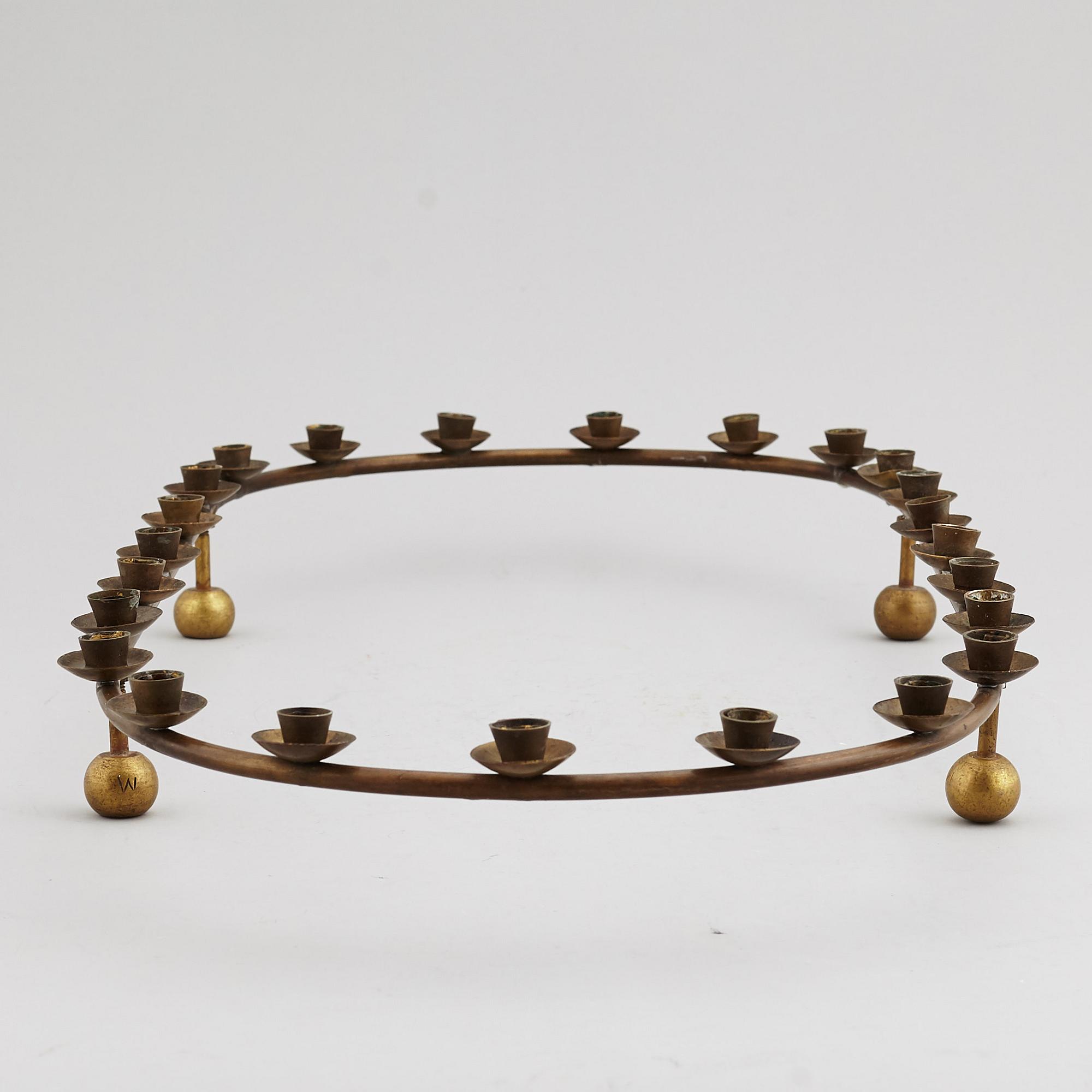 A mid 20th Century brass candle ring.