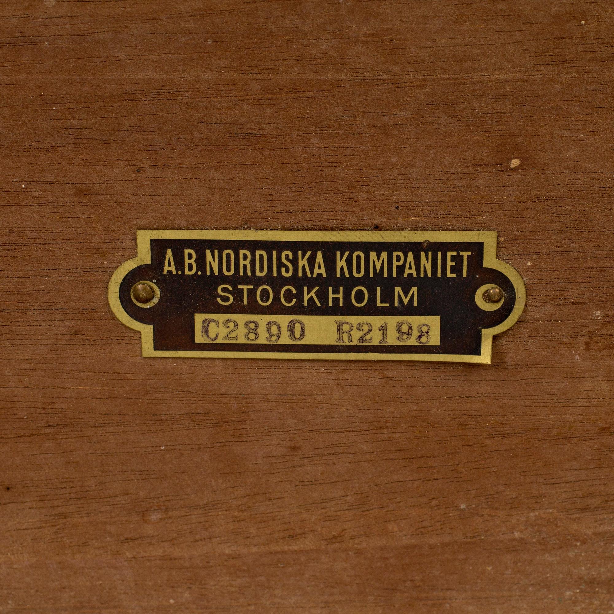 A mid 20th century mahogany veneered table from Nordiska Kompaniet (NK).