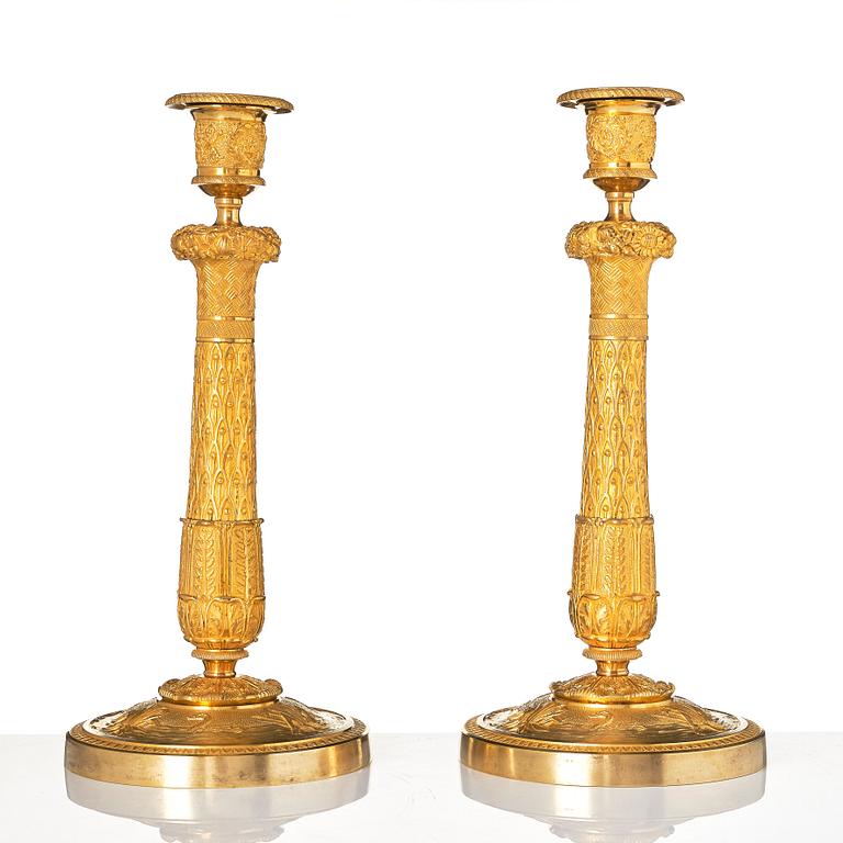 A pair of French Empire candlesticks.