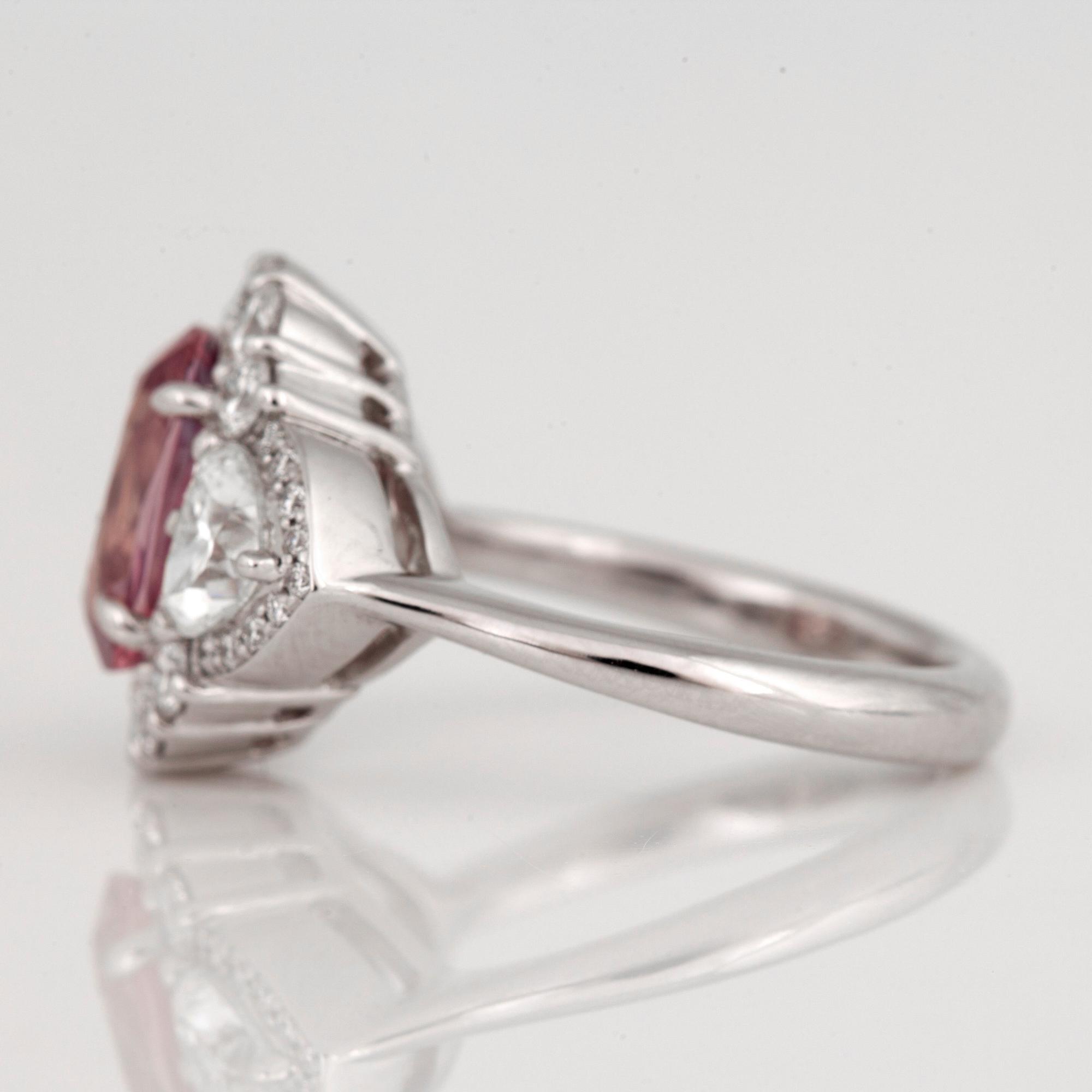 An untreated padparascha (orangy pink sapphire) and diamond ring.