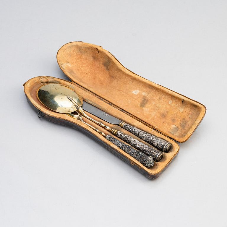 A possibly German 17/18th century parcel-gilt silver and filigree three-piece travel cutlery, unmarked.