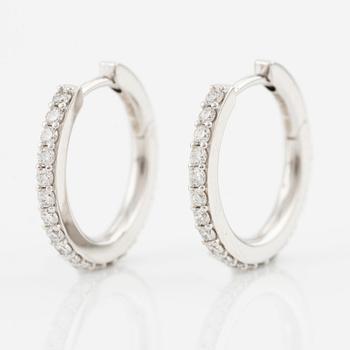 A pair of earrings in 18K white gold with round brilliant-cut diamonds.