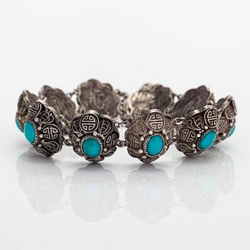 A bracelet and pair of earrings in silver with turquoises. Import marked Risto Aho, Helsinki 1964.