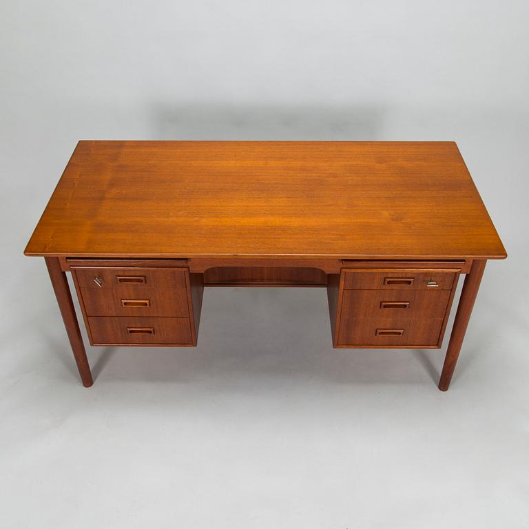 A wooden mid 20th century desk.