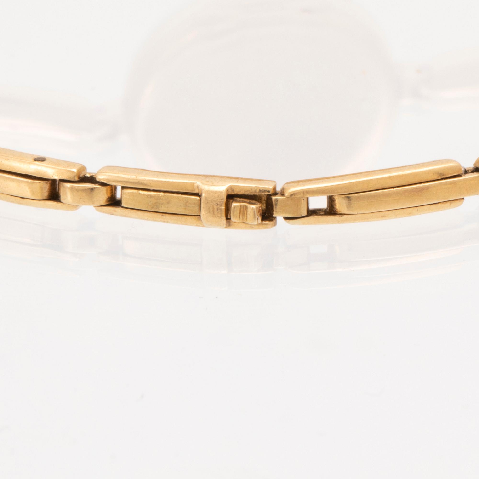 An 18K white and red gold watch set with round old cut diamonds.