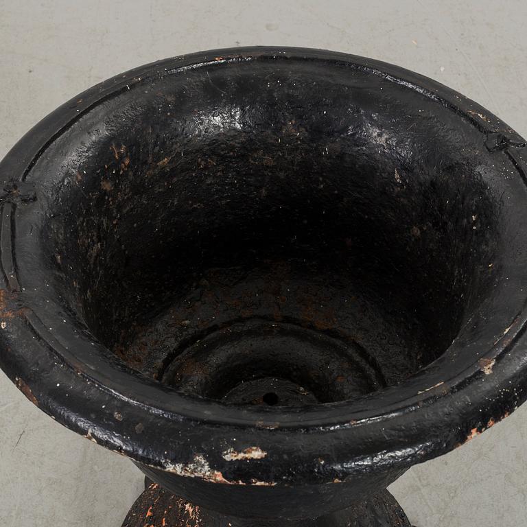 A CAST IRON GARDEN URN.