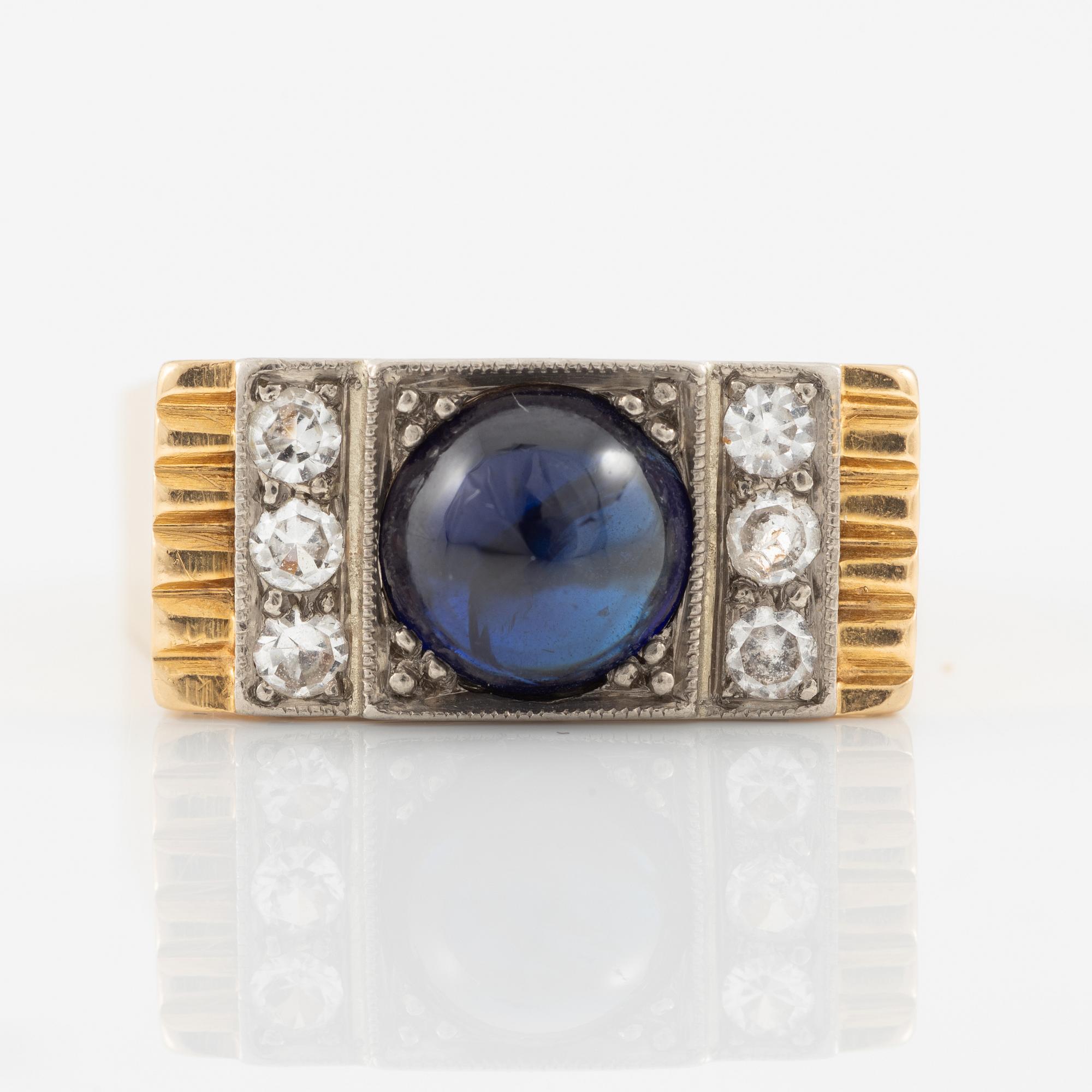 Ring 18K gold with cabochon-cut sapphire and white stones.