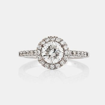 1325. A brilliant-cut diamond ring. Center stone 1.03 cts F/VS1, surrounded by 0.36 ct pavé-set diamonds.