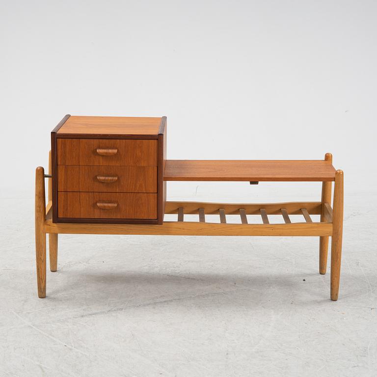 A teak chest of drawers with shelves, 1950's/60's.