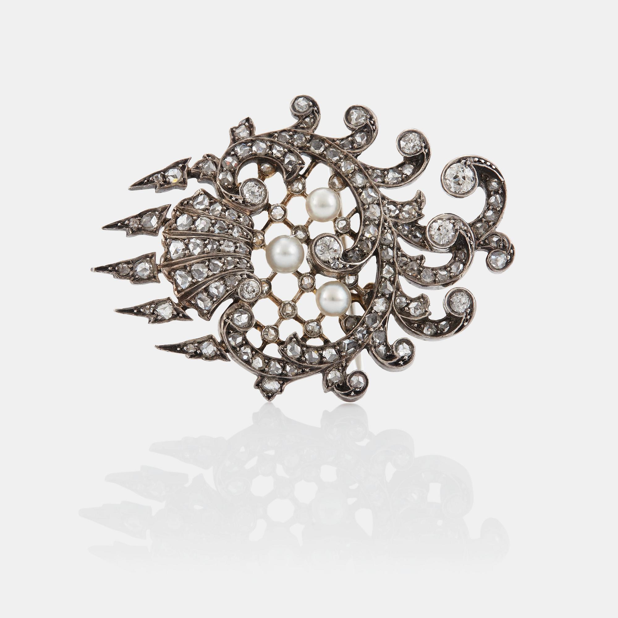 An 18K gold and silver brooch set with old- and rose-cut diamonds.