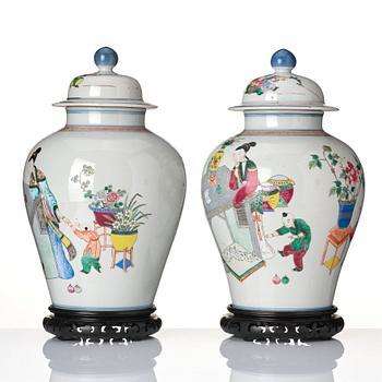 A pair of famille rose 'ladies and boys' vases with covers, late Qing dynasty.