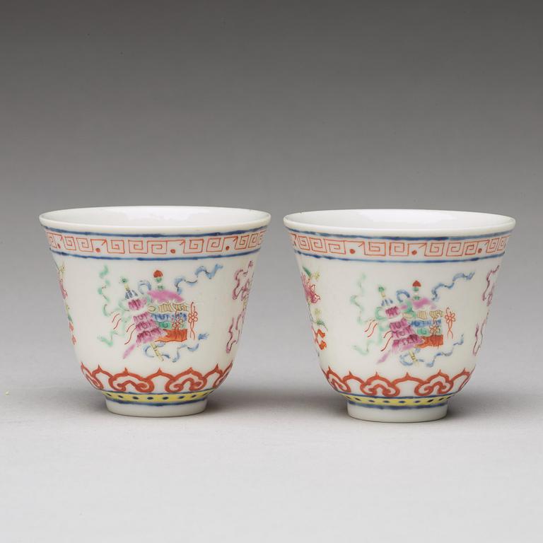 A pair of Chinese famille rose ba jixiang wine cups, Republic, with Guangxu six character mark.