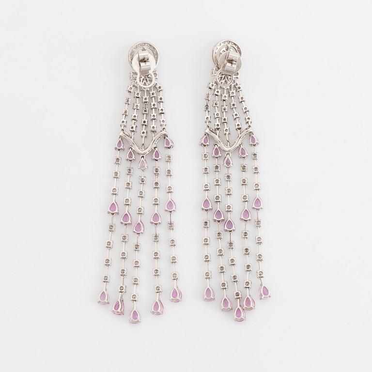 A pair of 18K white gold earrings set with faceted pink sapphires and round brilliant-cut diamonds.