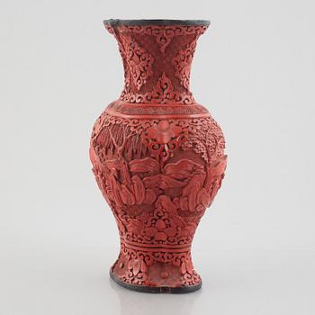 A red laquer vase, early 20th century.