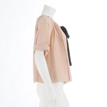 PRADA, a powder pink blouse with black ribbon. Size 40.
