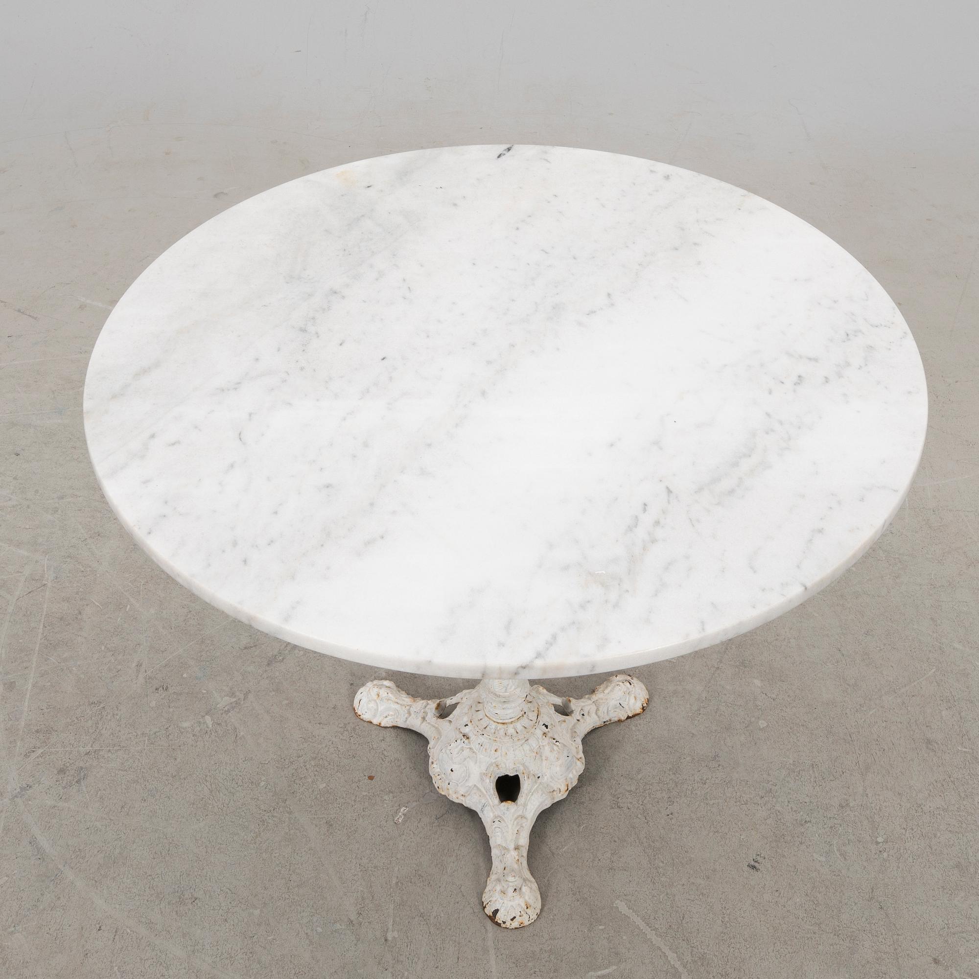 A marble and cast iron table 20th century.