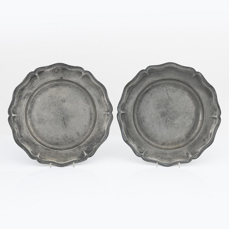 A pair of rococo pewter chargers, mid 18th Century.