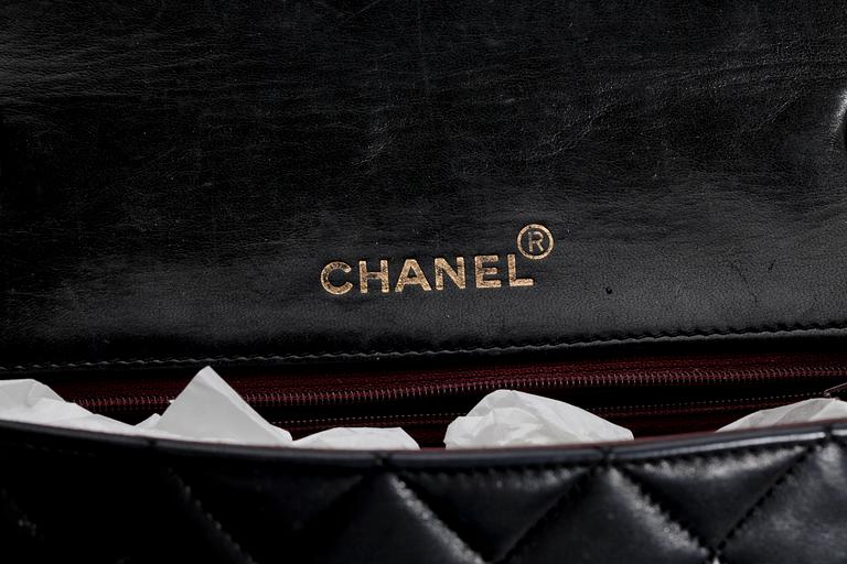 A black quilt leather shoulder bag by Chanel.