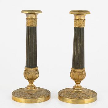 A pair of French Empire ormolu and patinated bronze candlesticks, first part of the 19th century.