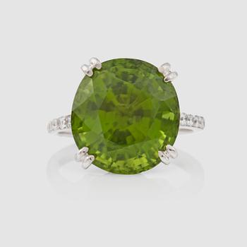 1123. A 14.10 ct peridot and 0.78 ct brilliant-cut diamond ring.