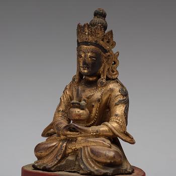 Two Sino-tibetan wooden and lacquered figures of buddha, late 19th Century.