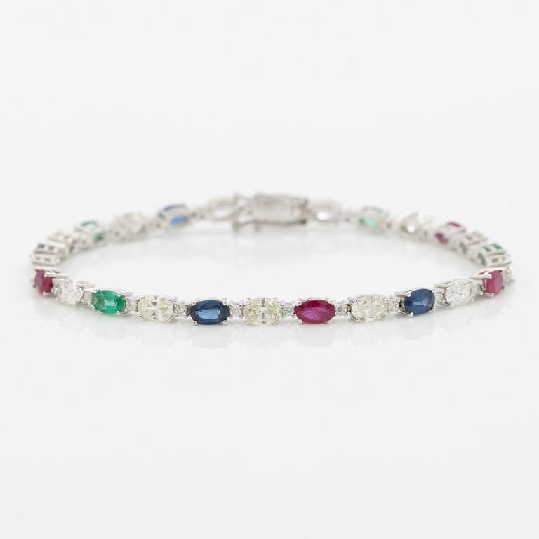 Bracelet 18K white gold set with faceted rubies, emeralds, sapphires, and round brilliant-cut diamonds.