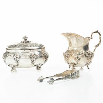 A silver sugar bowl, creamer and sugar tongs, 20th century.