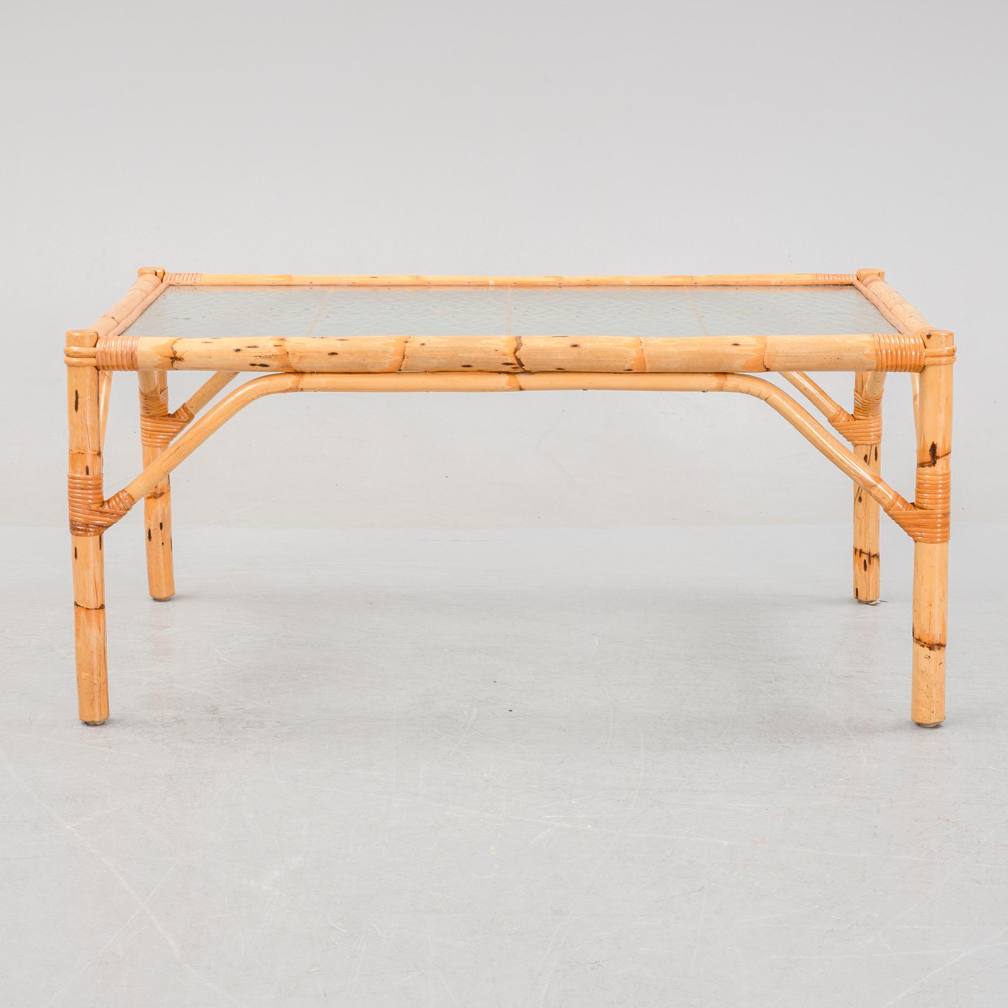 A set of two garden sofas, an armchair and a glass table, later part of the 20th Century.