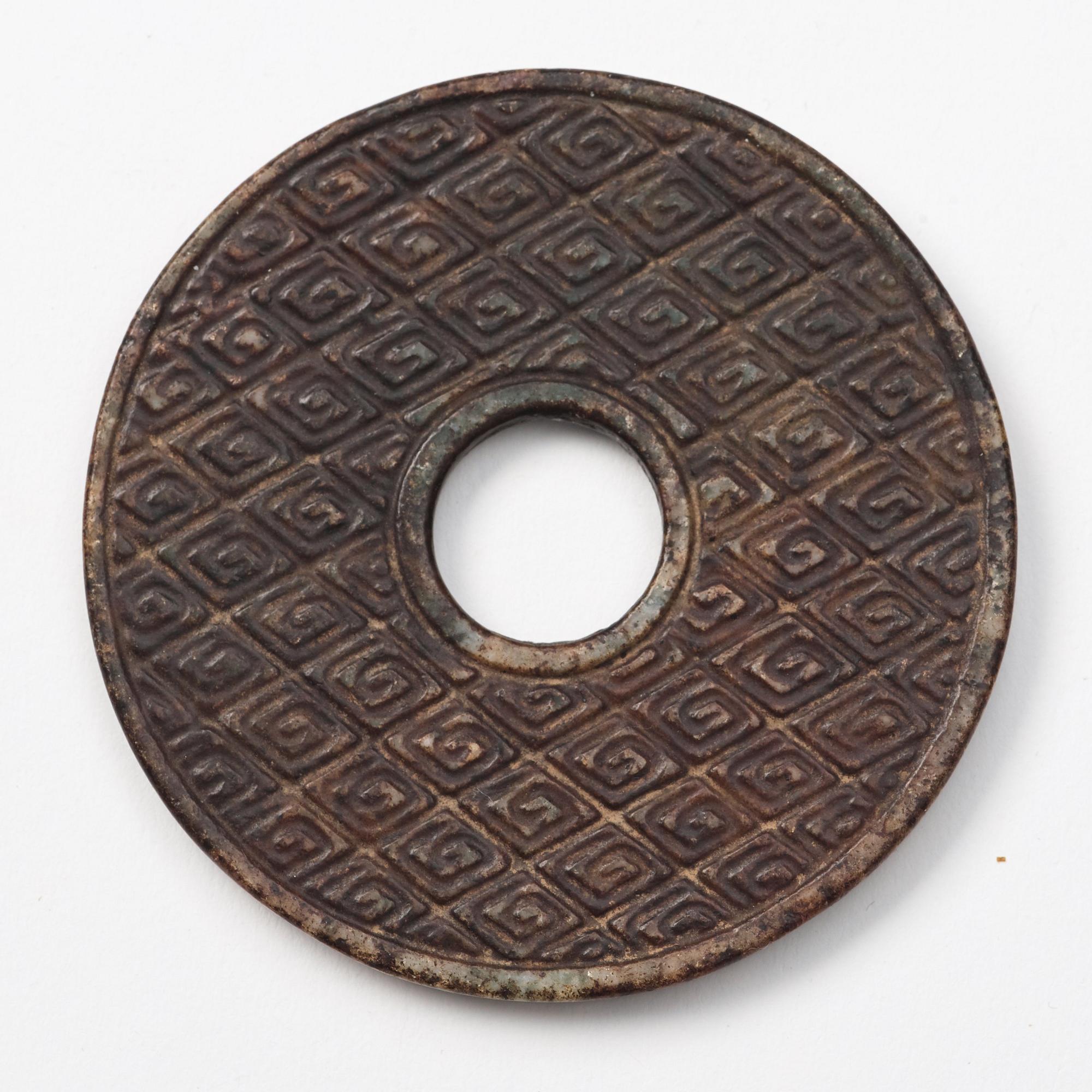 A group of three archaistic Chinese stone bi discs and two pendants.