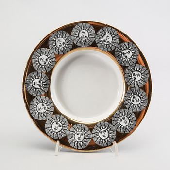 A st of three Piero Fornasetti porcelain plates.