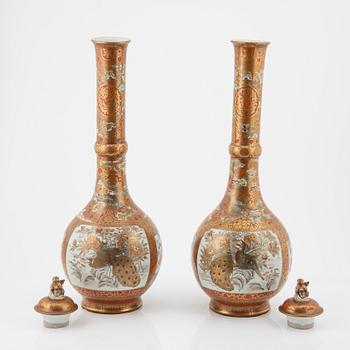 A pair of large Japanese porcelain vases with covers, Meiji period (1868-1912).