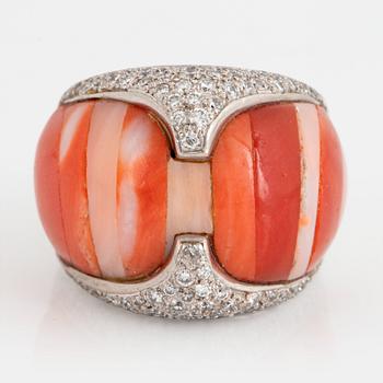 A Paul Binder ring in 18K white gold set with coral and round brillliant-cut diamonds.