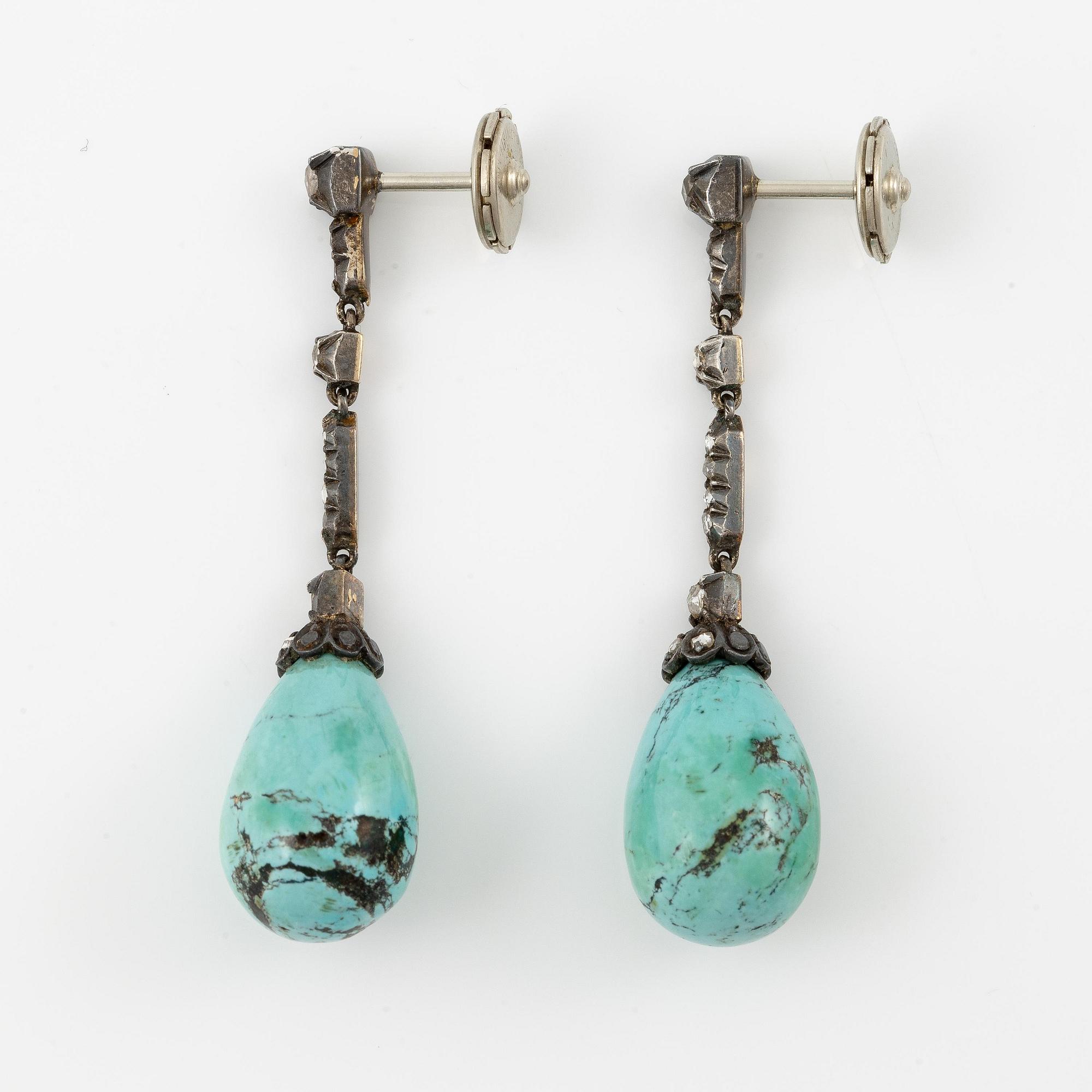 A pair of silver and 18K gold earrings with turquoise drops and rose-cut diamonds.
