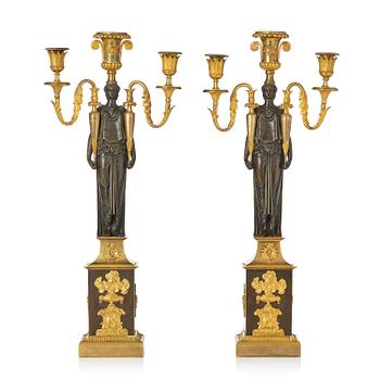 142. A pair of French Empire ormolu three-branch candelabra, Paris, early 19th century.