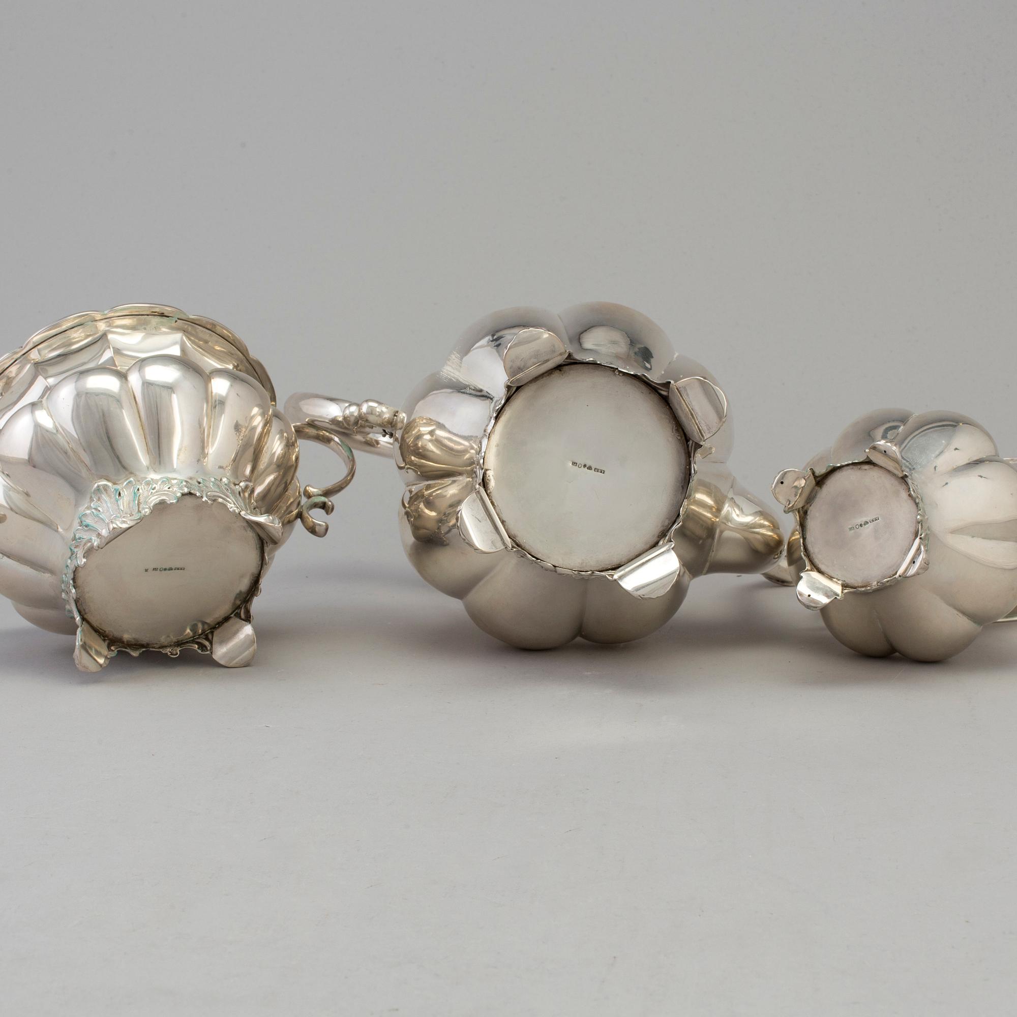 A three piece silver coffee set dated 1916-17.