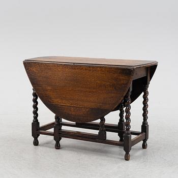 An oak baroque style gate leg table, 20th Century.