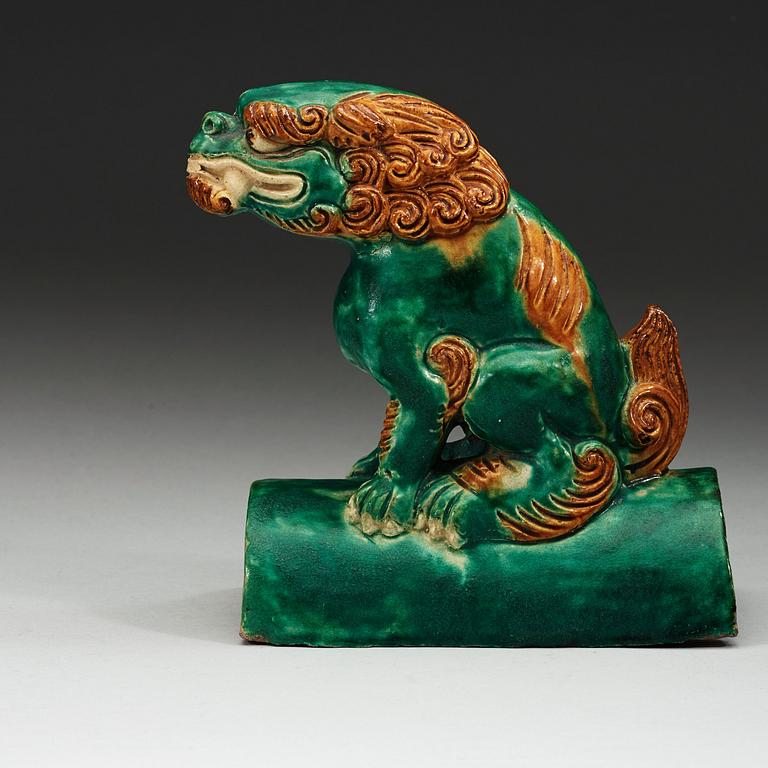 A sancai glazed roof tile figure of a mythological animal, Ming dynasty, 17th Century.