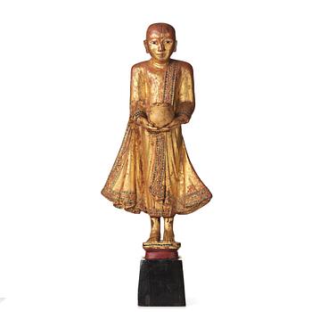 43. A wooden lacquered sculpture of a buddhist monk, Thailand, 20th Century.