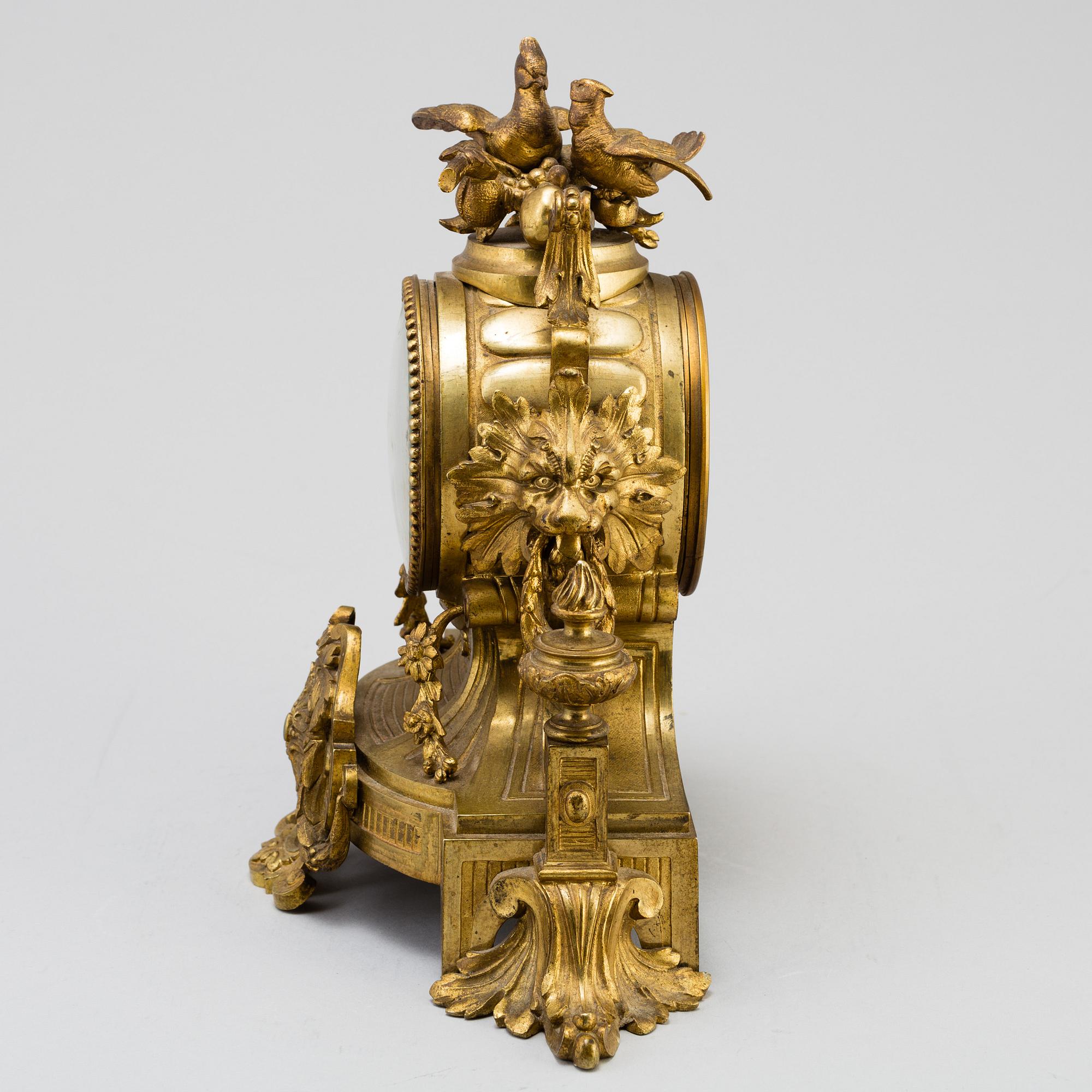 A table CLOCK and a pair of candelabra, second part of 19th century.