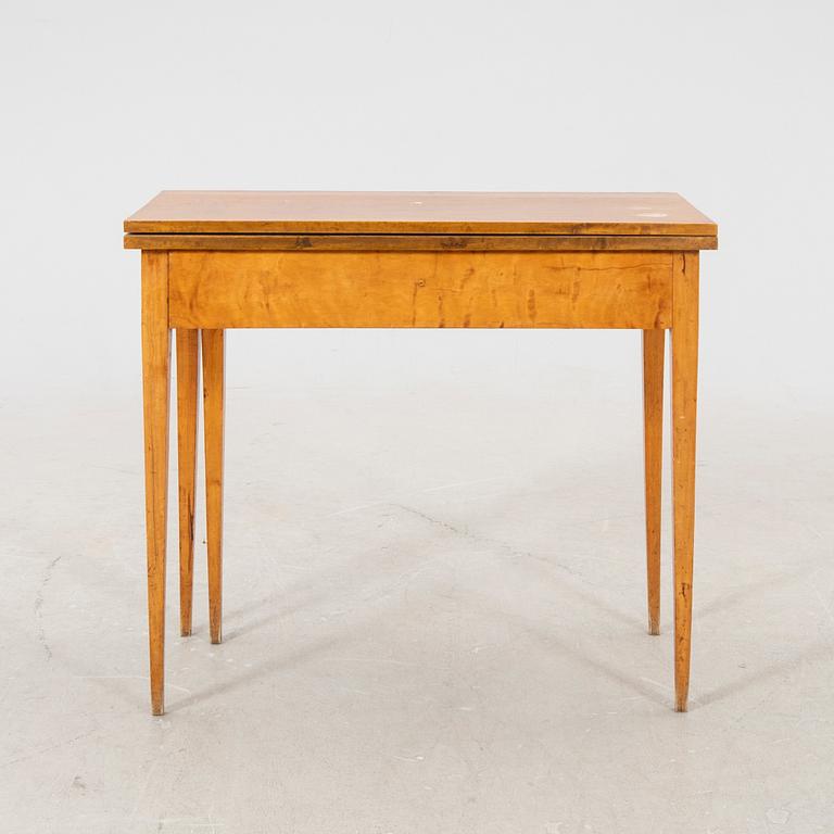 An earluy 1900s birch game table.