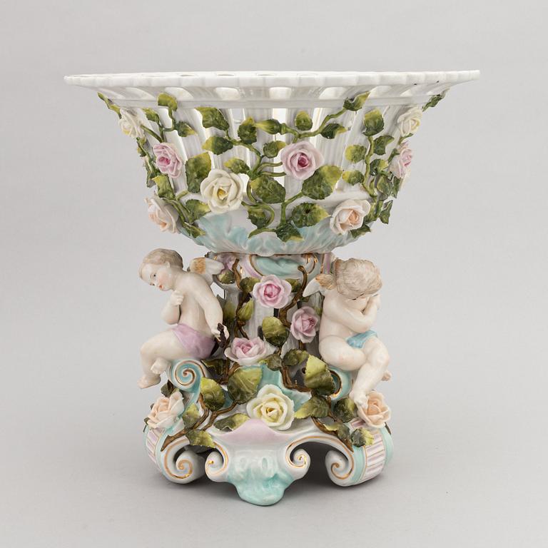 A pair of porcelain rococo style candelabra and a centerpiece bowl, Plaue, Germany, first half of the 20th century.