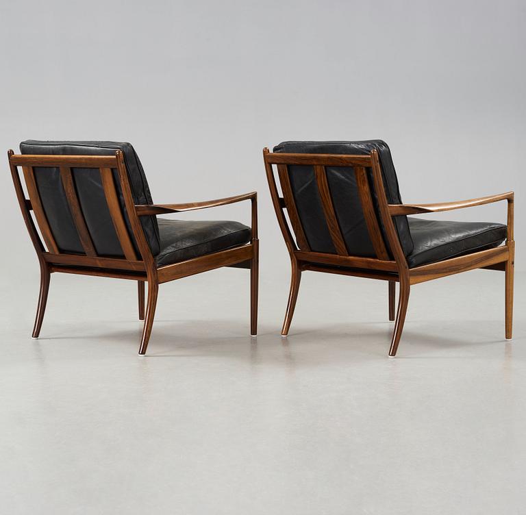 Ib Kofod-Larsen, a pair of palisander and black leather 'Samsö' armchairs, 1960's, for Thysell's, Anderslöv, Sweden.