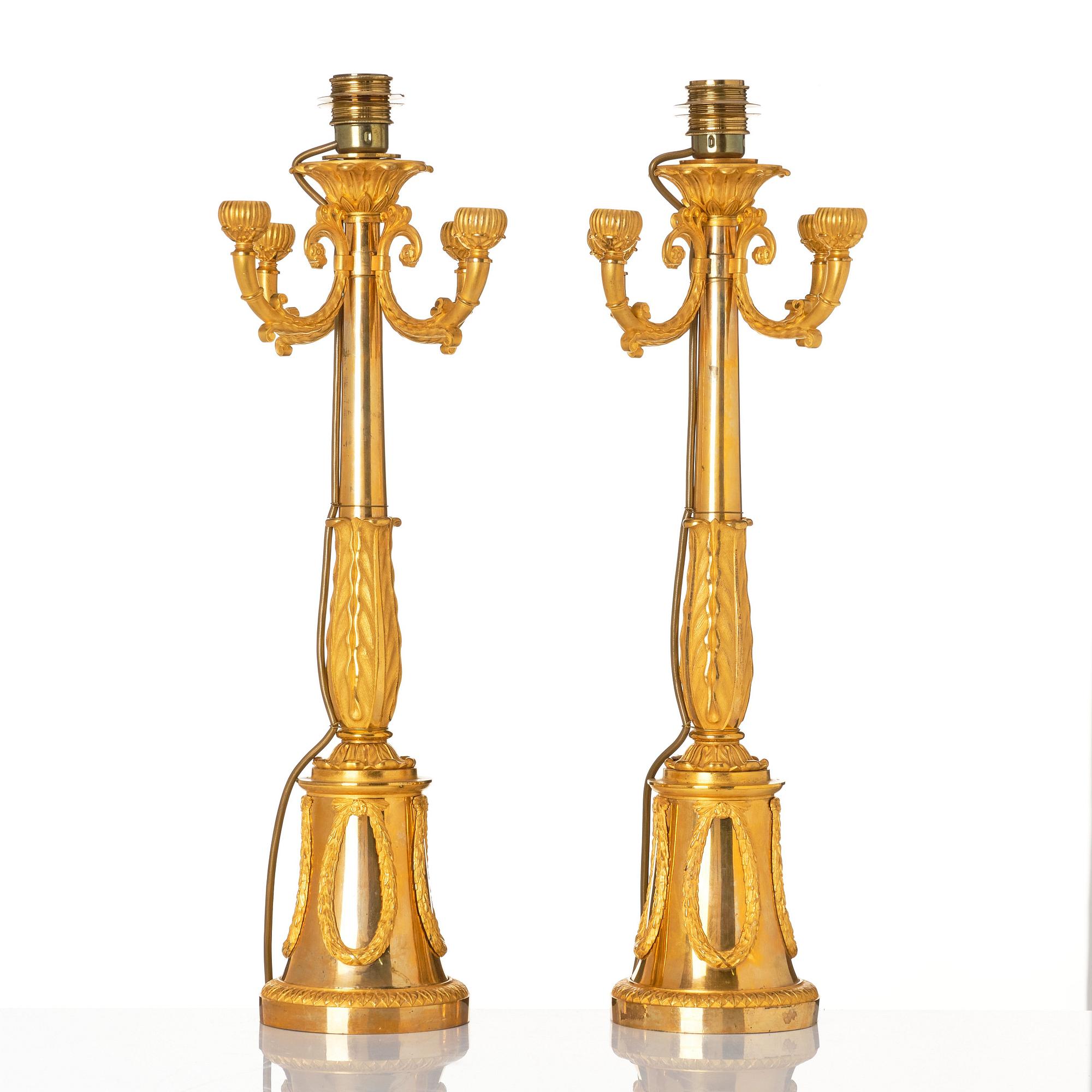 A pair of French Empire four-light candelabra (lamps), early 19th century.
