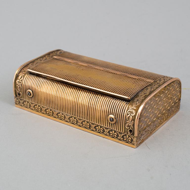 A brass music box, about 1900.