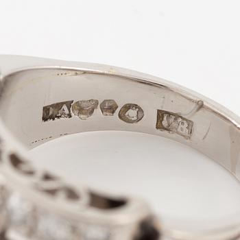 A platinum ring set with round brilliant and old-cut diamonds.
