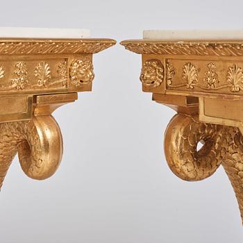 A pair of Swedish Empire carved and giltwood console tables, first half of the 19th century.